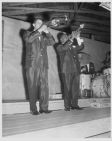 Louis Armstrong playing trumpet with man